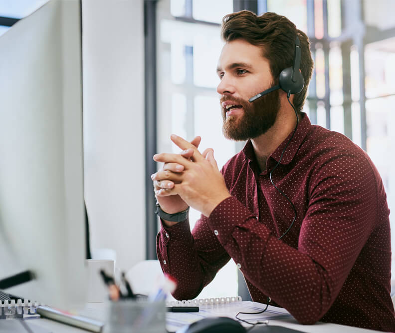 Banner image of a call center agent in a contact center office.